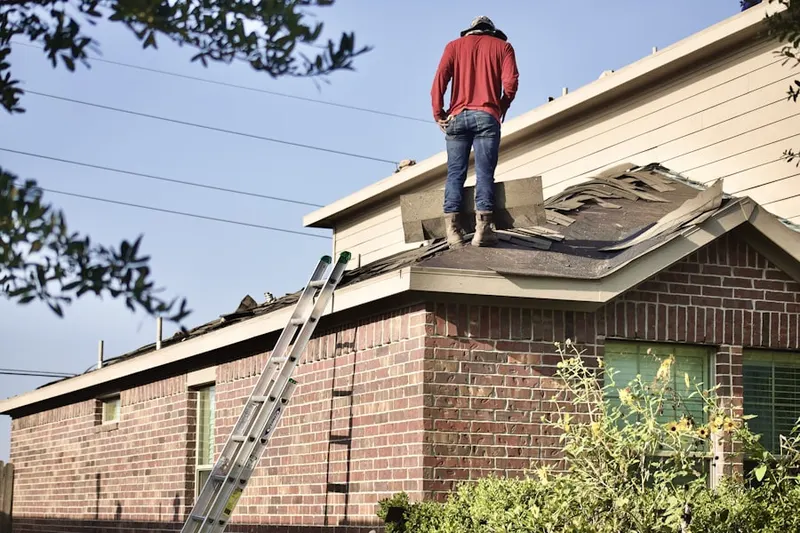 Professional roofer working on a residential roof in Akron